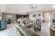 Open-concept living room showcasing tile floors connecting to kitchen and dining spaces at 1309 Piney Woods Path, The Villages, FL 32163