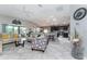 Open-concept living area with tile floors connecting to kitchen at 1309 Piney Woods Path, The Villages, FL 32163