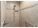 Large walk-in shower with decorative tile border and hand rails at 1309 Piney Woods Path, The Villages, FL 32163