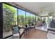Bright and airy sunroom with stone walls, tile flooring, and large windows that brings the outdoors in at 1309 Piney Woods Path, The Villages, FL 32163