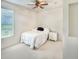 Simple bedroom with white walls, a twin bed, white carpet, and a bedside table at 13332 Via Roma Cir, Clermont, FL 34711
