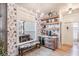 Charming dining area with floral wallpaper, a window bench, custom bar, and floating wood shelves at 13332 Via Roma Cir, Clermont, FL 34711