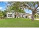 Beautiful single-story home with a lush lawn and mature trees offering great curb appeal at 13332 Via Roma Cir, Clermont, FL 34711