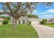 Charming single-story home with a well-maintained lawn and attached two-car garage at 13332 Via Roma Cir, Clermont, FL 34711
