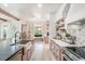 Well-designed kitchen with stainless steel appliances, an island with a sink, and ample countertop space at 13332 Via Roma Cir, Clermont, FL 34711