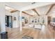 Open-concept living area with wood beam accents, fireplace, and seamless flow from the kitchen at 13332 Via Roma Cir, Clermont, FL 34711