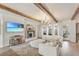 Bright living room with wood beam ceilings, fireplace, modern decor, and a view to the backyard at 13332 Via Roma Cir, Clermont, FL 34711