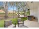 Screened-in patio with synthetic grass, trees, seating, and a view of the backyard at 13332 Via Roma Cir, Clermont, FL 34711