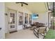 Relax on the screened patio, featuring a ceiling fan, a television, ample seating, and an outdoor dining area at 13332 Via Roma Cir, Clermont, FL 34711
