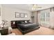 Cozy bedroom with a dark-wood bed, natural light, and tasteful decor at 14350 Se 36Th Ave, Summerfield, FL 34491