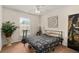 Cozy bedroom with carpet flooring, ceiling fan, and a large window offering natural light at 14350 Se 36Th Ave, Summerfield, FL 34491
