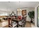 Inviting dining room with a chandelier, an area rug, and a view into the living area at 14350 Se 36Th Ave, Summerfield, FL 34491