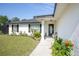 Inviting front porch with decorative columns and manicured landscaping at 14350 Se 36Th Ave, Summerfield, FL 34491