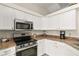 Modern kitchen featuring stainless steel appliances and white cabinetry at 14350 Se 36Th Ave, Summerfield, FL 34491