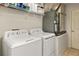 Practical laundry area with machines, shelving, and tiled flooring at 14350 Se 36Th Ave, Summerfield, FL 34491