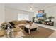 Bright living room with a comfortable sectional couch, modern decor, and a large flat-screen TV at 14350 Se 36Th Ave, Summerfield, FL 34491