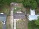 Bird's-eye view of a home with mature trees, a well-kept lawn, and fenced backyard at 14466 Se 45Th Ct, Summerfield, FL 34491