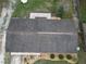 Aerial shot of the roof, landscaping, and patio offering a clear home perspective at 14466 Se 45Th Ct, Summerfield, FL 34491