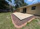 Spacious backyard featuring a brick-paver patio outlined with decorative stones at 14466 Se 45Th Ct, Summerfield, FL 34491