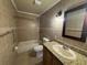 Bathroom featuring a granite counter, modern light fixture and tiled walls at 14466 Se 45Th Ct, Summerfield, FL 34491