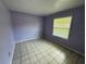 Bedroom featuring tile floors, neutral walls and a window letting in natural light at 14466 Se 45Th Ct, Summerfield, FL 34491