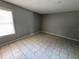 Neutral tone bedroom featuring tile floors and a window letting in natural light at 14466 Se 45Th Ct, Summerfield, FL 34491