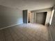 Bedroom with tiled floors and a view into the closet and ensuite bathroom at 14466 Se 45Th Ct, Summerfield, FL 34491