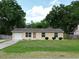 Charming single-story home with well-maintained lawn, tidy landscaping, and an attached garage at 14466 Se 45Th Ct, Summerfield, FL 34491
