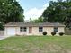Charming single-story home with a well-maintained lawn and an attached one car garage at 14466 Se 45Th Ct, Summerfield, FL 34491