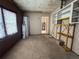 A tidy garage with storage solutions and ample room, leading to extra space for projects at 14466 Se 45Th Ct, Summerfield, FL 34491