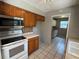 Traditional style kitchen with stainless steel appliances, tile floors and wood cabinets at 14466 Se 45Th Ct, Summerfield, FL 34491