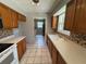 Traditional style kitchen with tile floors, laminate counters, and wooden cabinets at 14466 Se 45Th Ct, Summerfield, FL 34491