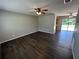 A spacious living room features luxury vinyl plank flooring and ceiling fans at 14466 Se 45Th Ct, Summerfield, FL 34491