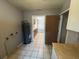 Utility room with water heater and laminate counters and door leading to the kitchen at 14466 Se 45Th Ct, Summerfield, FL 34491