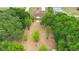 Aerial view of the home featuring an expansive backyard with mature trees and a pergola at 14490 Se 96Th Ter, Summerfield, FL 34491