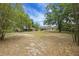 Expansive backyard featuring mature trees including bamboo and a pergola at 14490 Se 96Th Ter, Summerfield, FL 34491