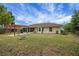 View of the back of the house featuring a wooden pergola, a screened-in porch and a fire pit at 14490 Se 96Th Ter, Summerfield, FL 34491