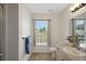 Bathroom with a plant, window, and shower with glass doors at 14490 Se 96Th Ter, Summerfield, FL 34491