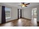 Bedroom with a ceiling fan, wood-look flooring, and natural lighting at 14490 Se 96Th Ter, Summerfield, FL 34491
