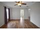 Bedroom featuring ceiling fan, wood-look flooring, and bathroom access at 14490 Se 96Th Ter, Summerfield, FL 34491