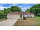 Charming single-story home with a spacious driveway, attached garage, and well-maintained landscaping at 14490 Se 96Th Ter, Summerfield, FL 34491