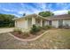 A welcoming two-car garage residence with well-maintained landscaping, and a charming front walkway at 14490 Se 96Th Ter, Summerfield, FL 34491
