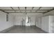 Spacious two-car garage features ample storage with cabinets and shelving; ready for vehicles and projects at 14490 Se 96Th Ter, Summerfield, FL 34491