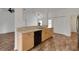 Well-lit kitchen featuring wood cabinets, black appliances, and wood-look vinyl flooring throughout at 14490 Se 96Th Ter, Summerfield, FL 34491