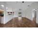 This open-concept living space includes wood-look flooring and direct access to the kitchen and outdoor patio at 14490 Se 96Th Ter, Summerfield, FL 34491