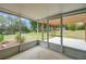 View of the screened porch and landscaped backyard with a wooden pergola and plenty of space at 14490 Se 96Th Ter, Summerfield, FL 34491