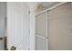 Bathroom shower with glass doors and a white door to the hallway at 14490 Se 96Th Ter, Summerfield, FL 34491