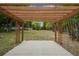 View of the wooden pergola on a concrete slab overlooking the expansive backyard at 14490 Se 96Th Ter, Summerfield, FL 34491