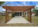 View of the wooden pergola and screened-in porch on the back of the home at 14490 Se 96Th Ter, Summerfield, FL 34491