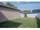 Well-maintained backyard featuring a lush green lawn, a white fence, and tidy landscaping, ideal for outdoor enjoyment at 14832 Royal Poinciana Dr, Orlando, FL 32828